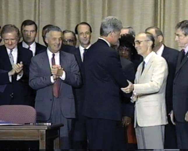 Former Fahe President, Dave Lollis, shakes the hand of President Bill Clinton after introducing him at the signing of the legislation establishing the CDFI Fund.