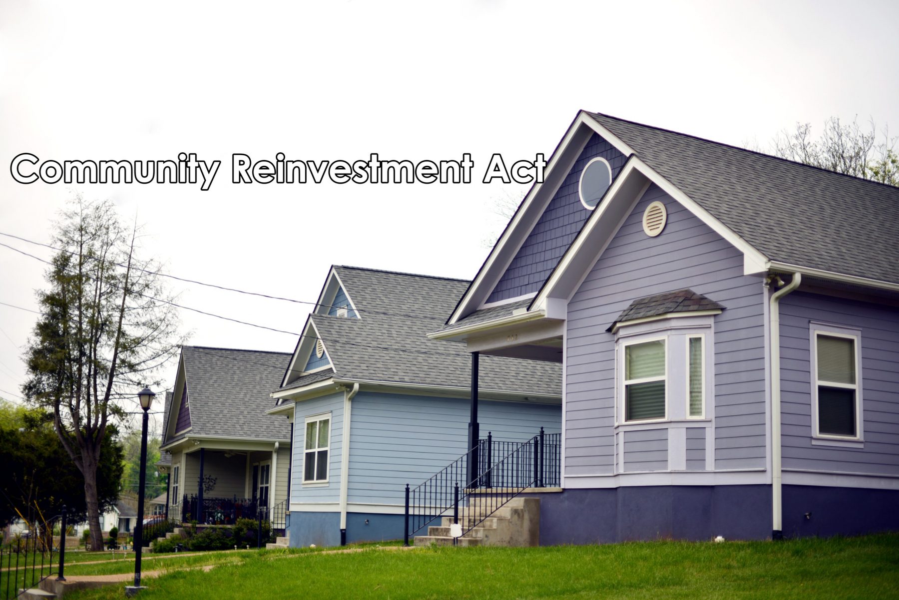 Three multi color one-story homes are in a row.