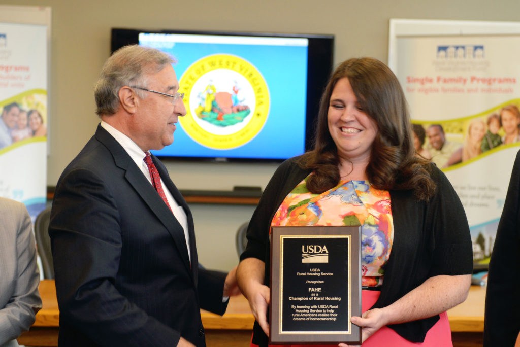 USDA RD Director Tony Hernandez presenting an award to Laura Meadows of Fahe.