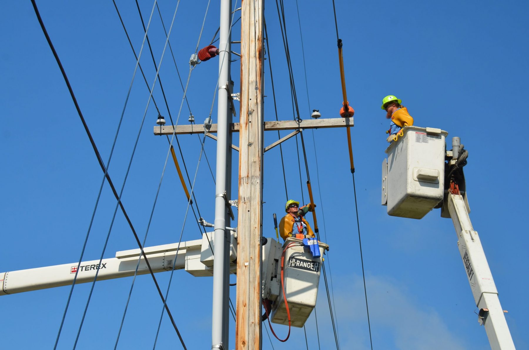 Utility workers working on power lines.