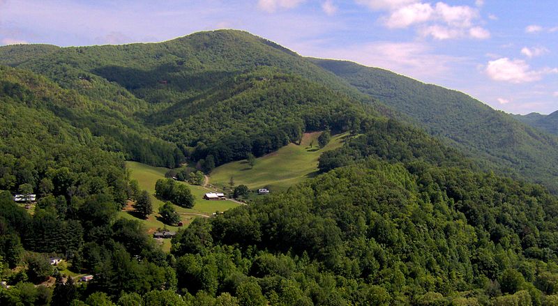Appalachian mountain scape with a houses on the hills below.