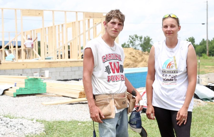 Justin and Mandy McClellan standing outside of a home construction site.