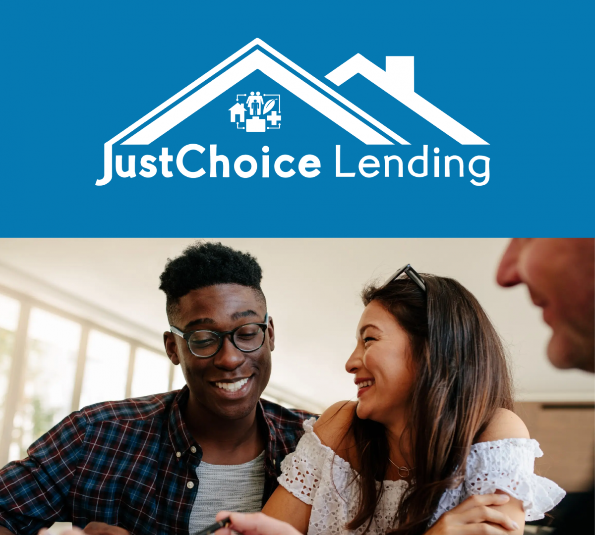 A young African American man and young asian woman are smiling and signing the paperwork for a new home.